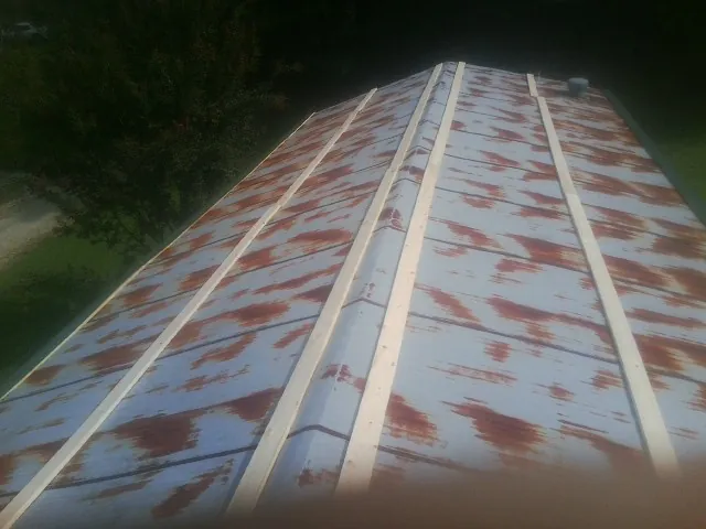 Rusted metal roof panels with new wood purlins before replacement — Storm Damage Roof Repair in Buchanan Dam by Roofing Brothers